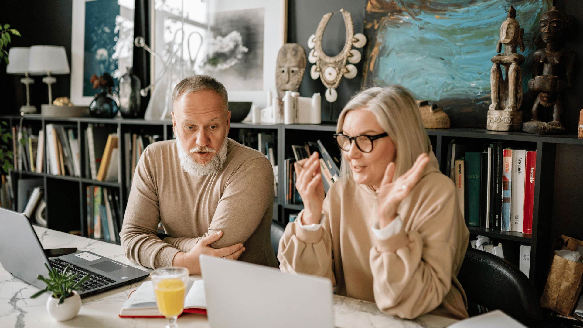 older couple talking in front of laptop