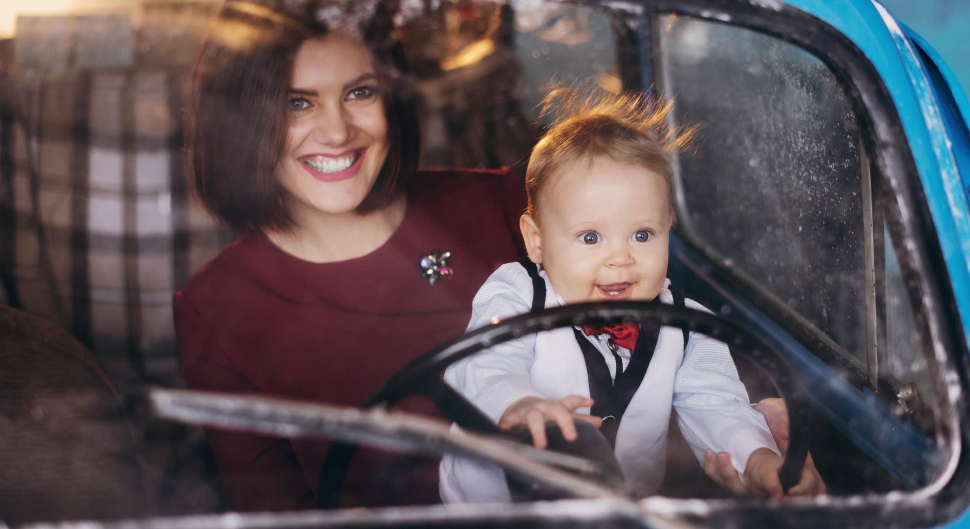 woman driving with baby in car without seatbelt