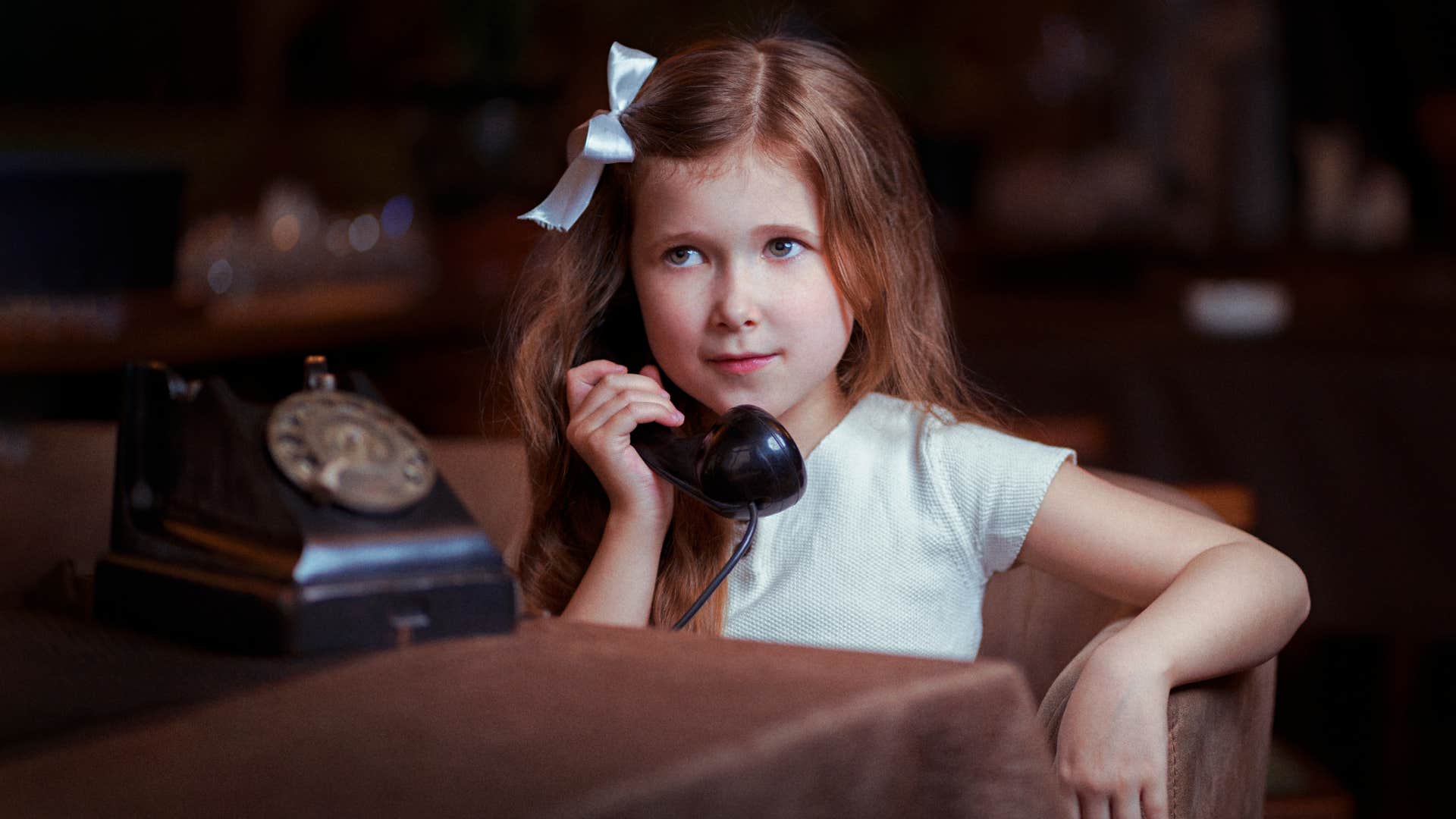 girl talking on rotary phone