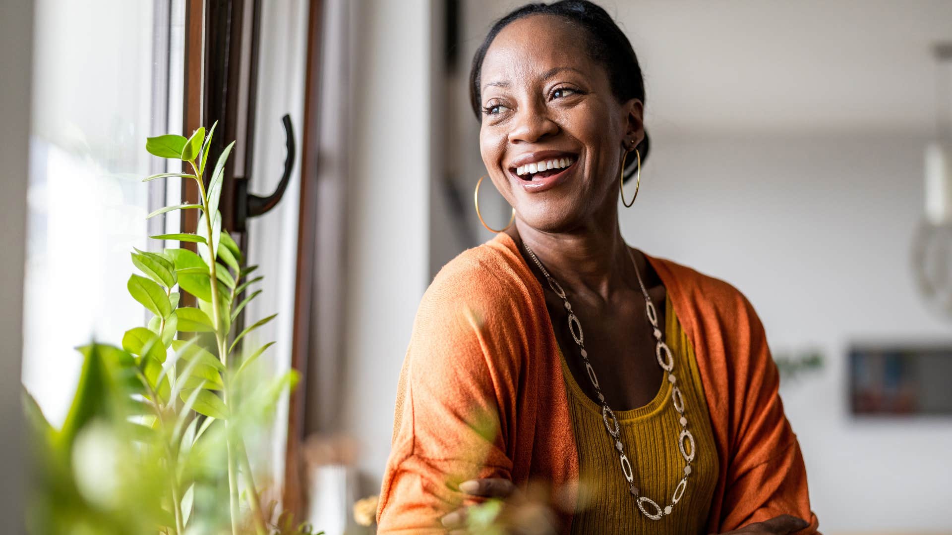 Woman smiling and looking out the window.