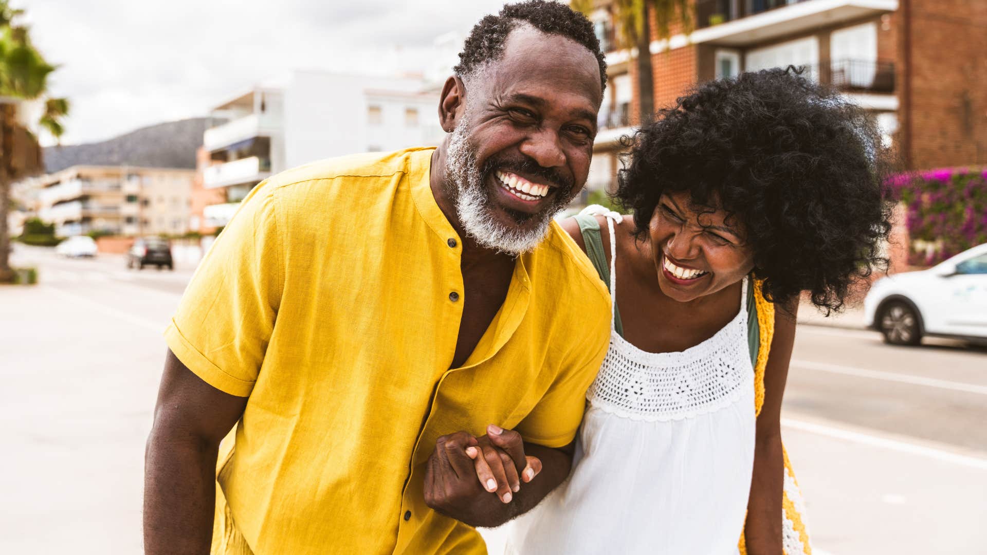 Couple smiling and walking together outside.