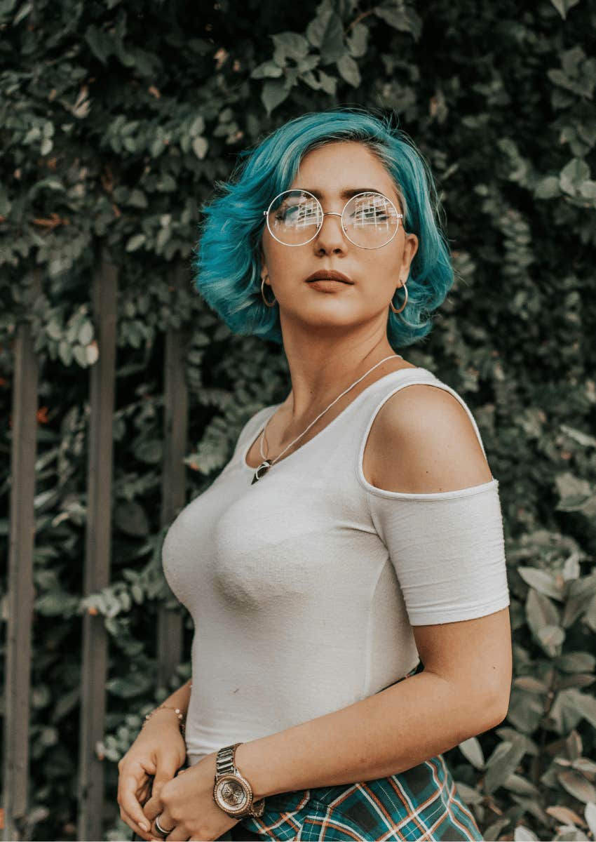 confident young woman with blue hair