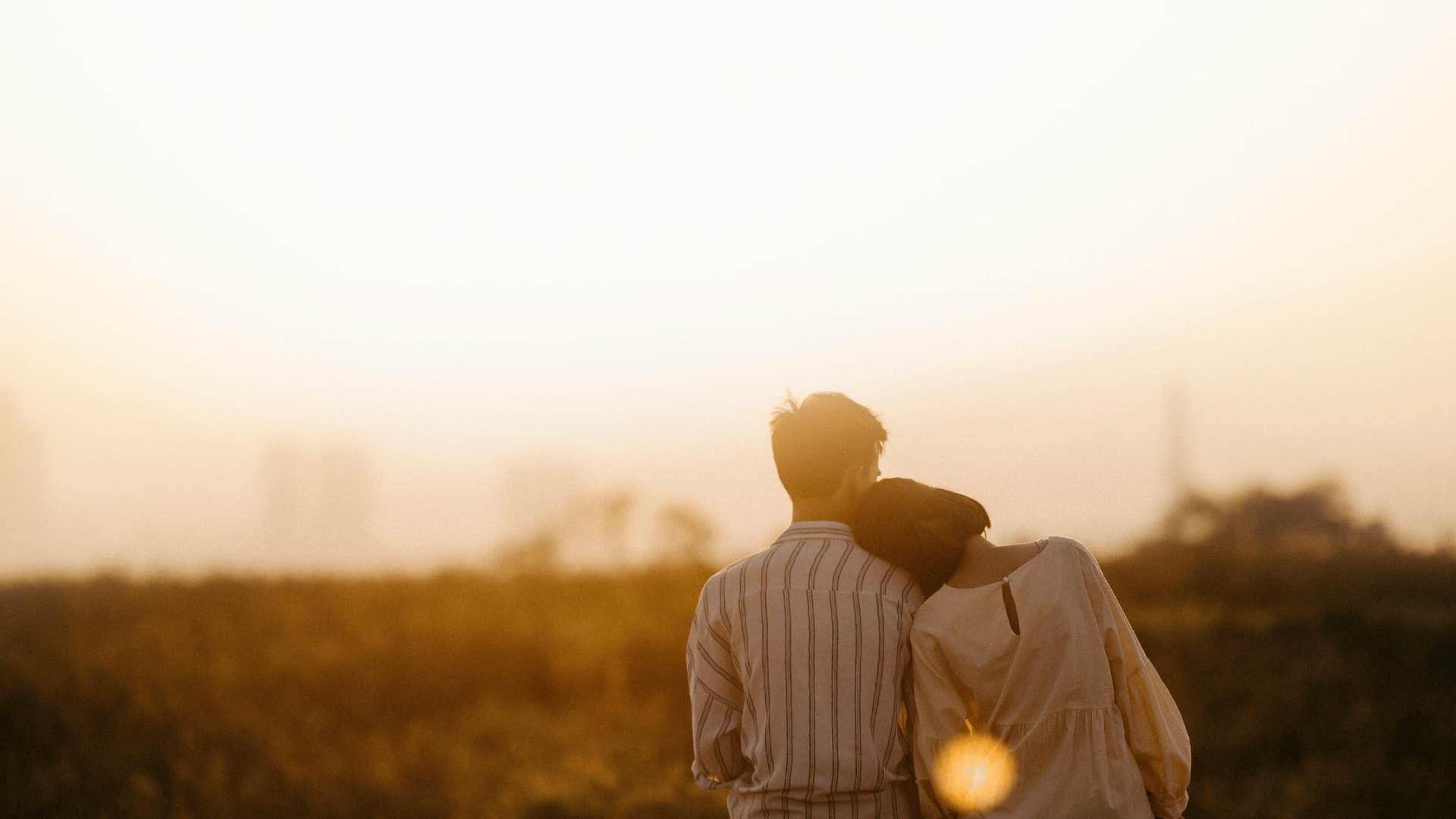 woman with her head on man's shoulder