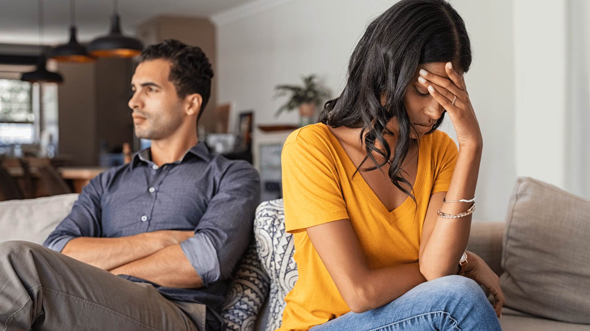 woman upset sitting next to man