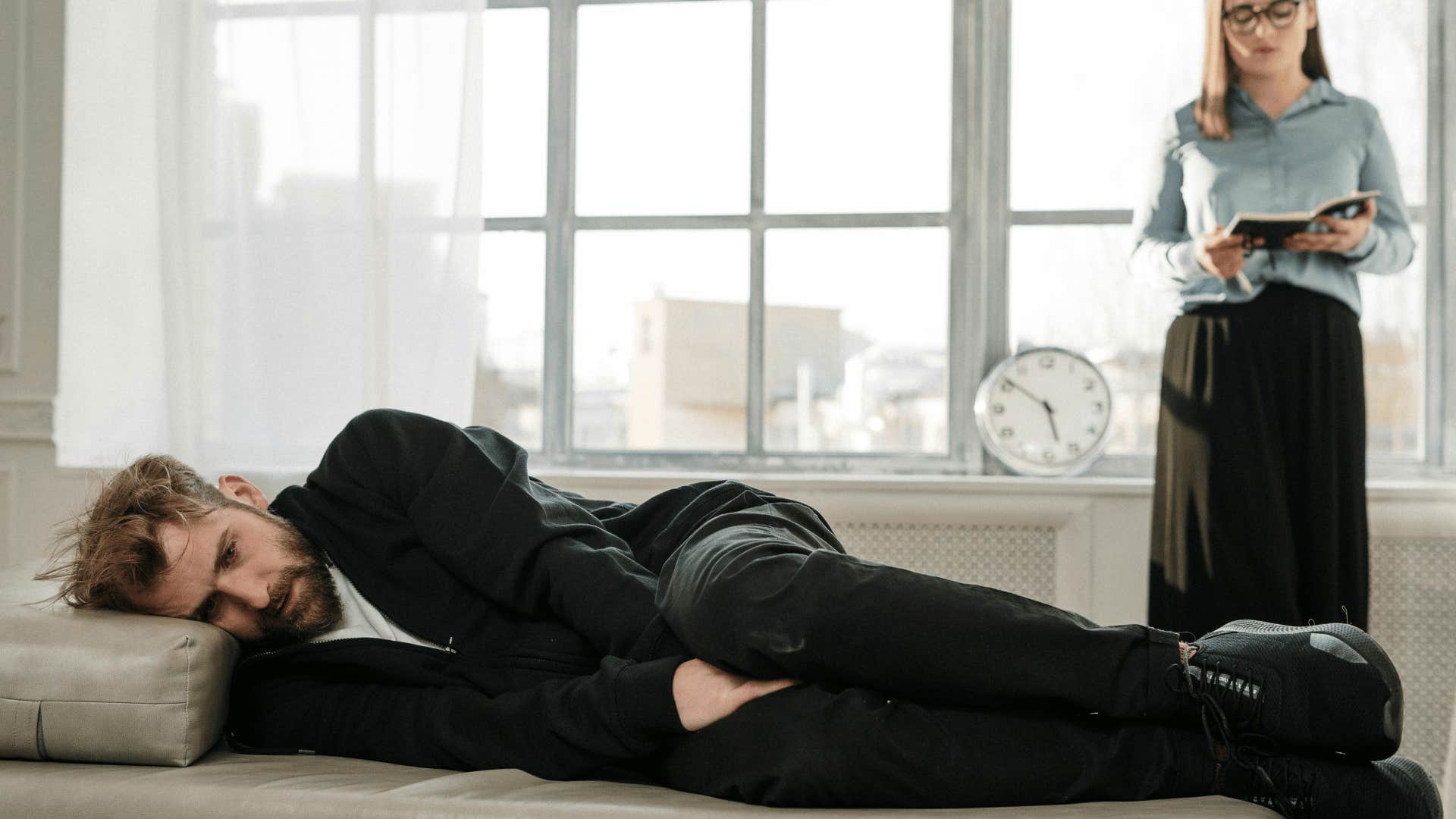 man lying on couch with woman next to him