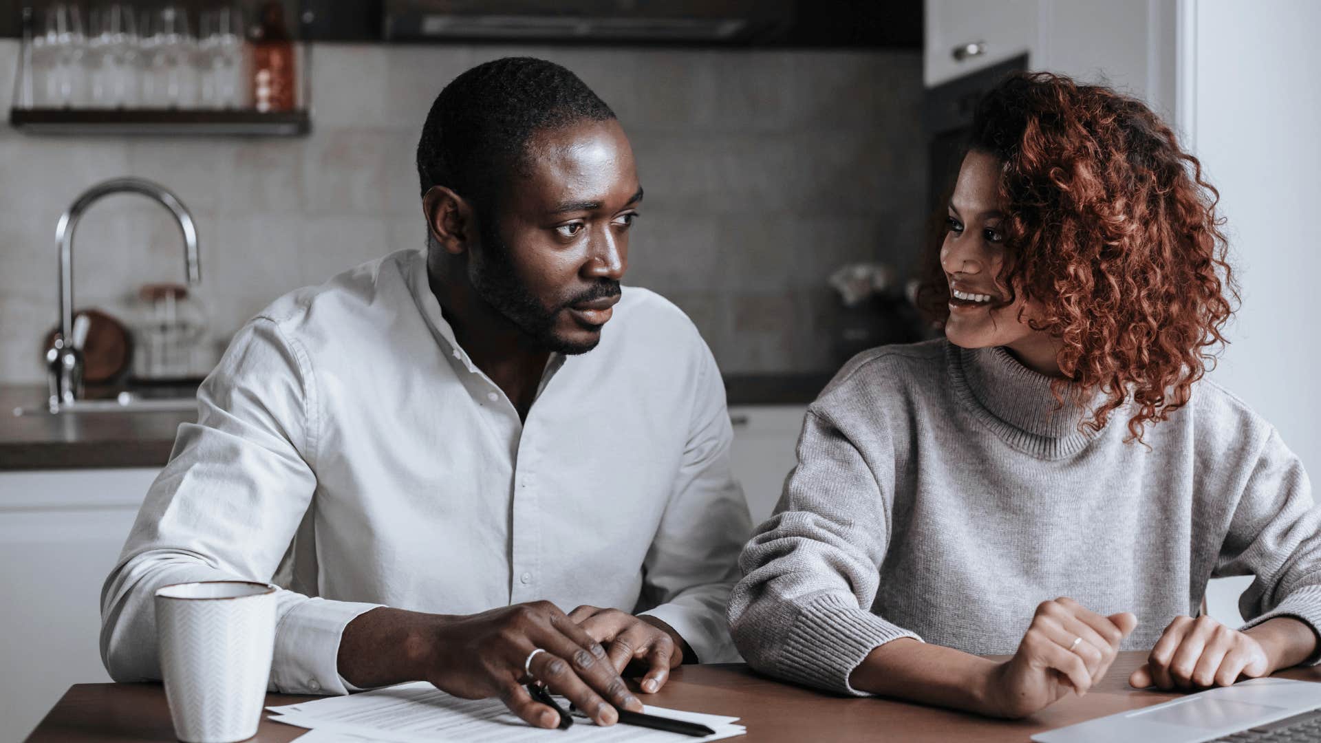 couple talking in front of laptop