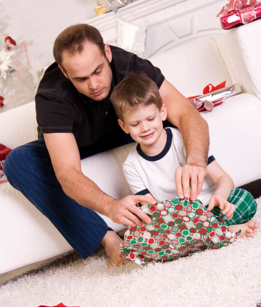 dad and son opening Christmas gift