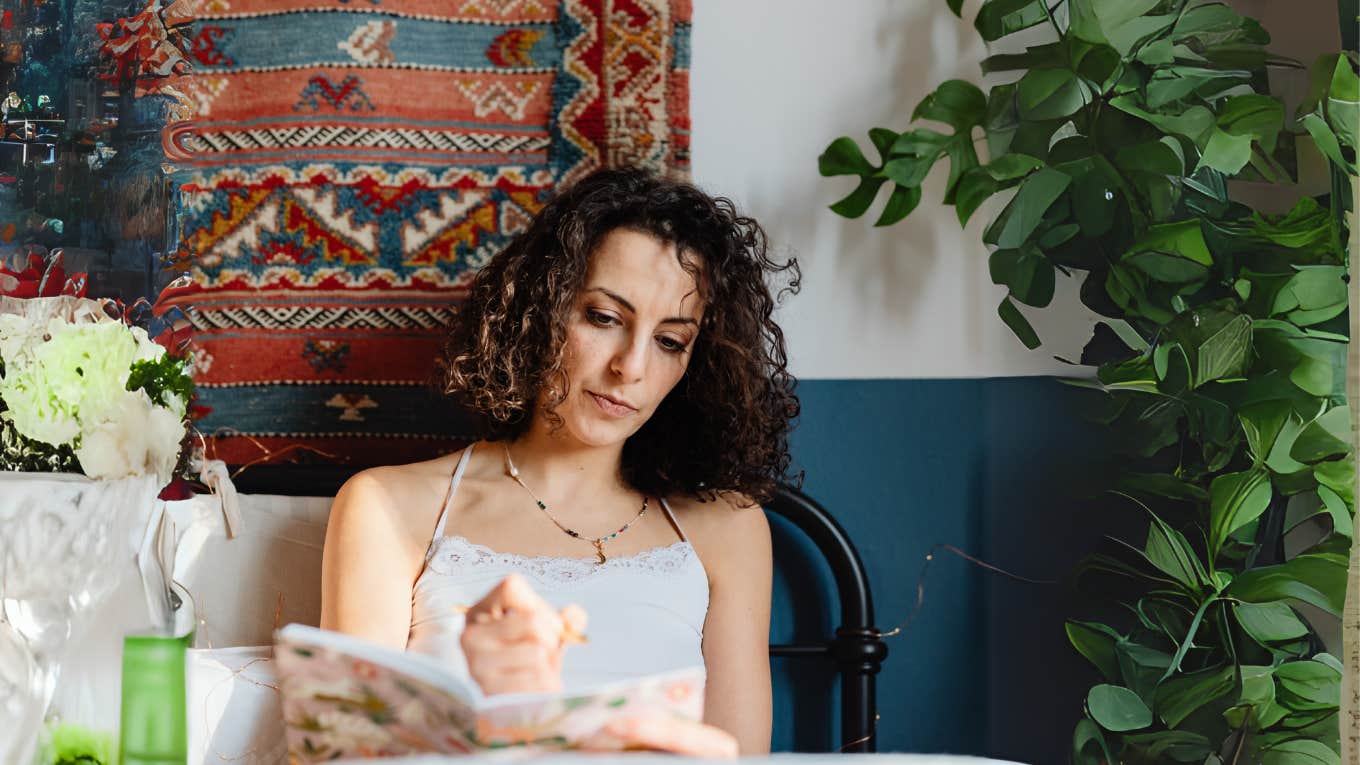 Woman journaling after a long day of high stress.