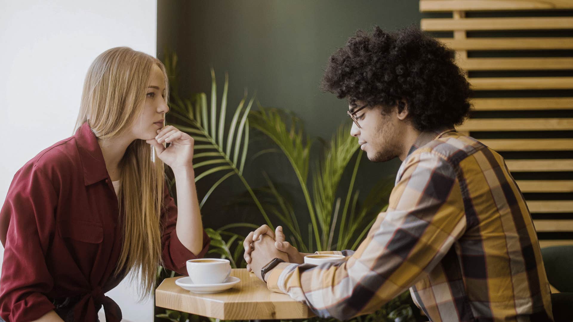 woman sitting across the table and staring at man