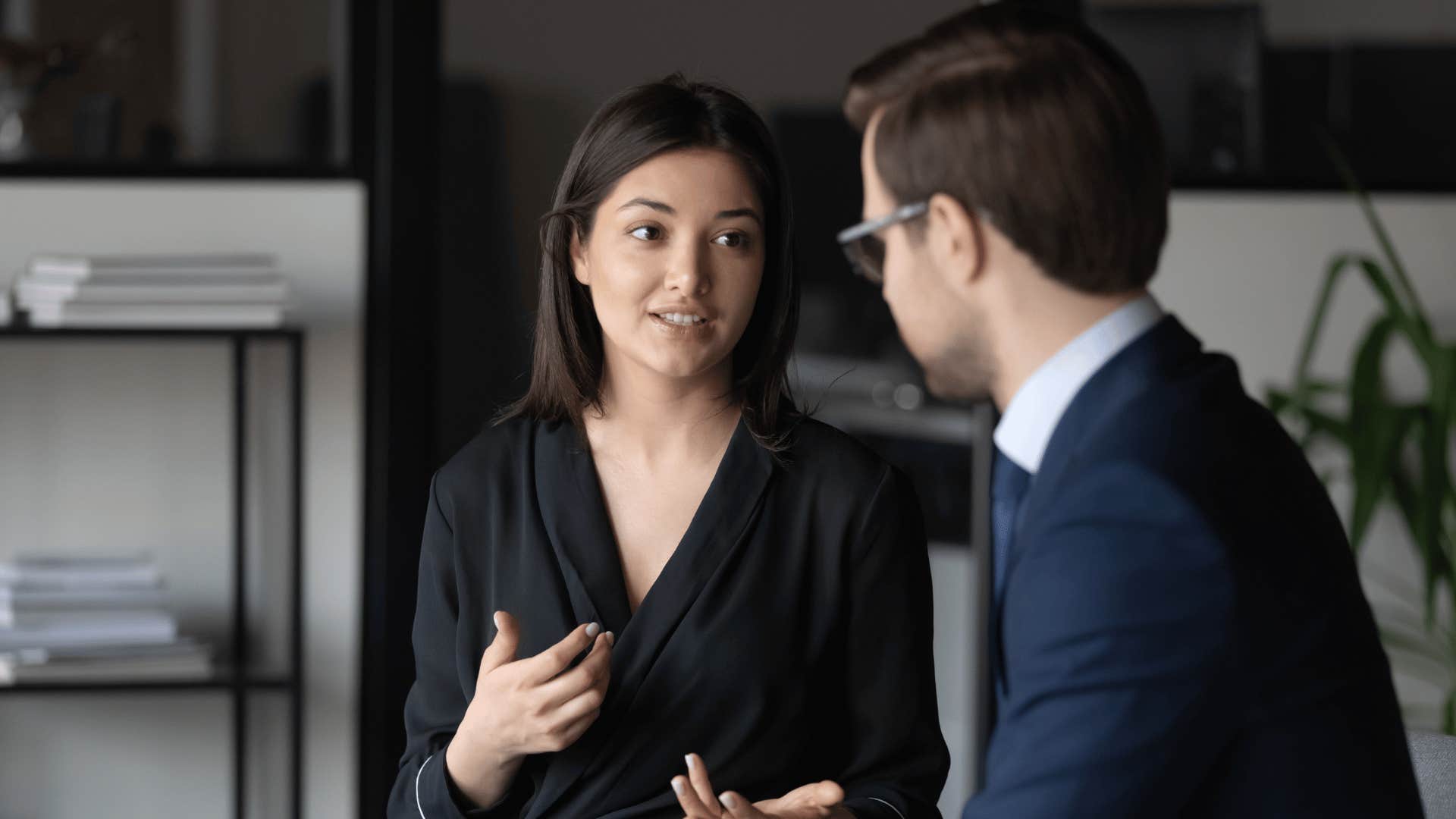 man and woman talking to each other at work