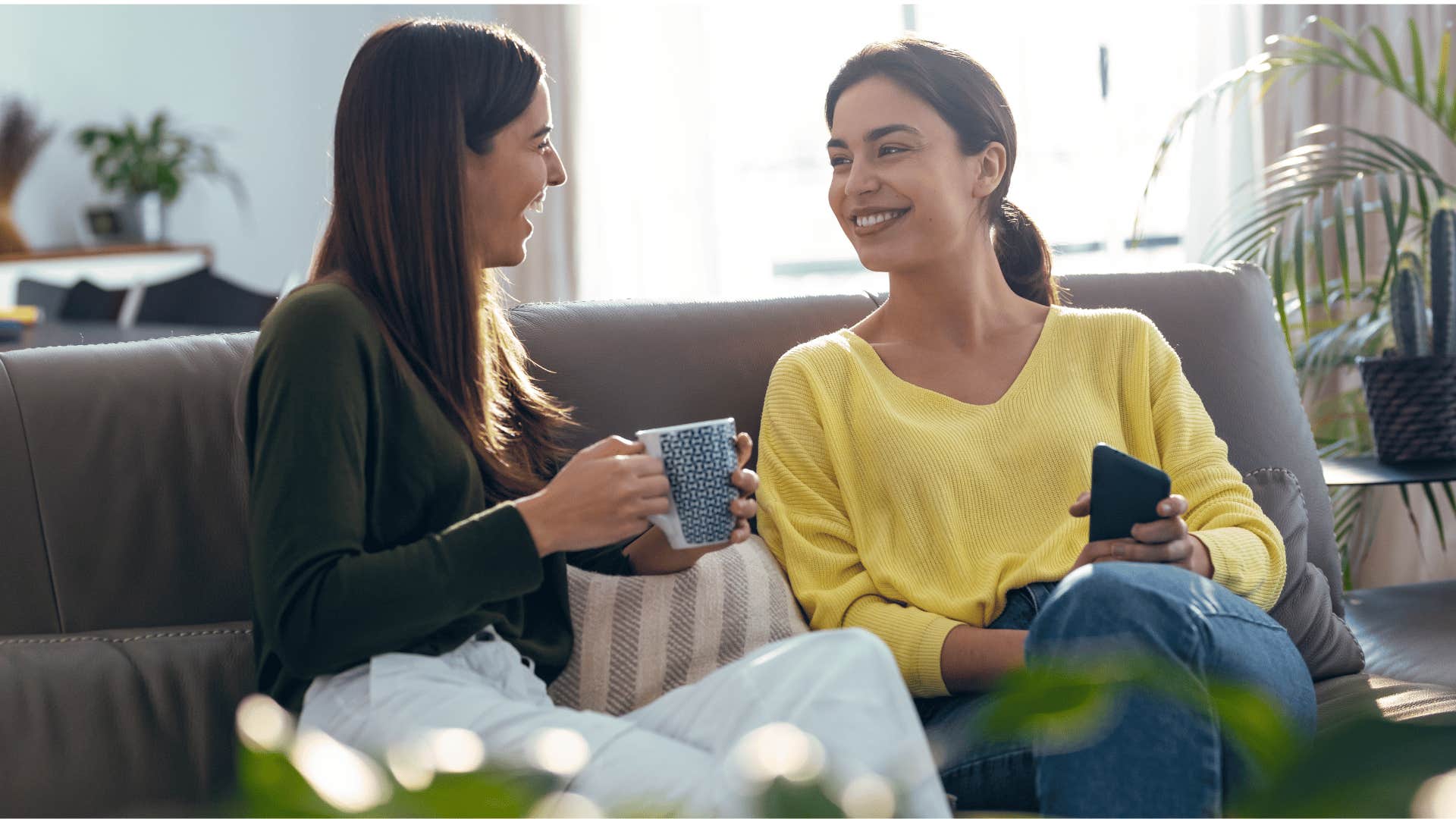 two women chatting on the couch