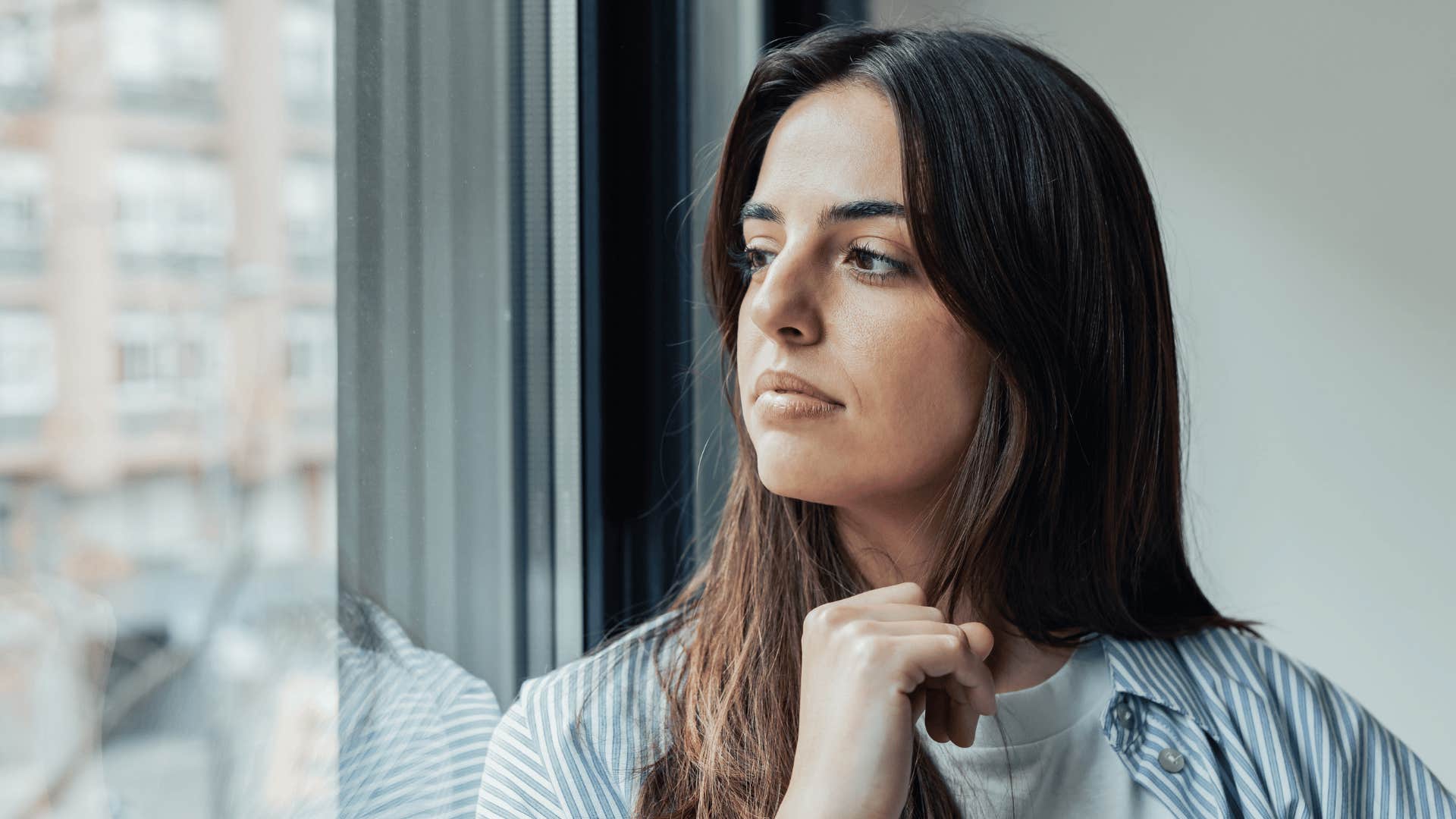 woman staring out the window