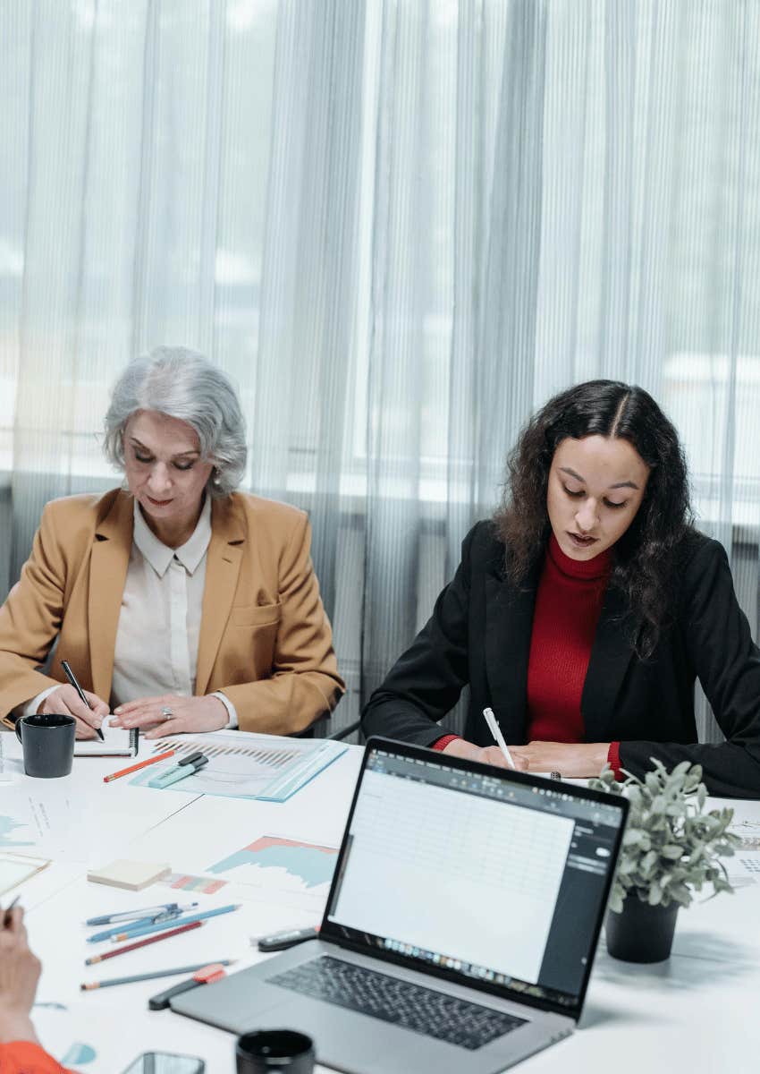 different aged coworkers taking notes