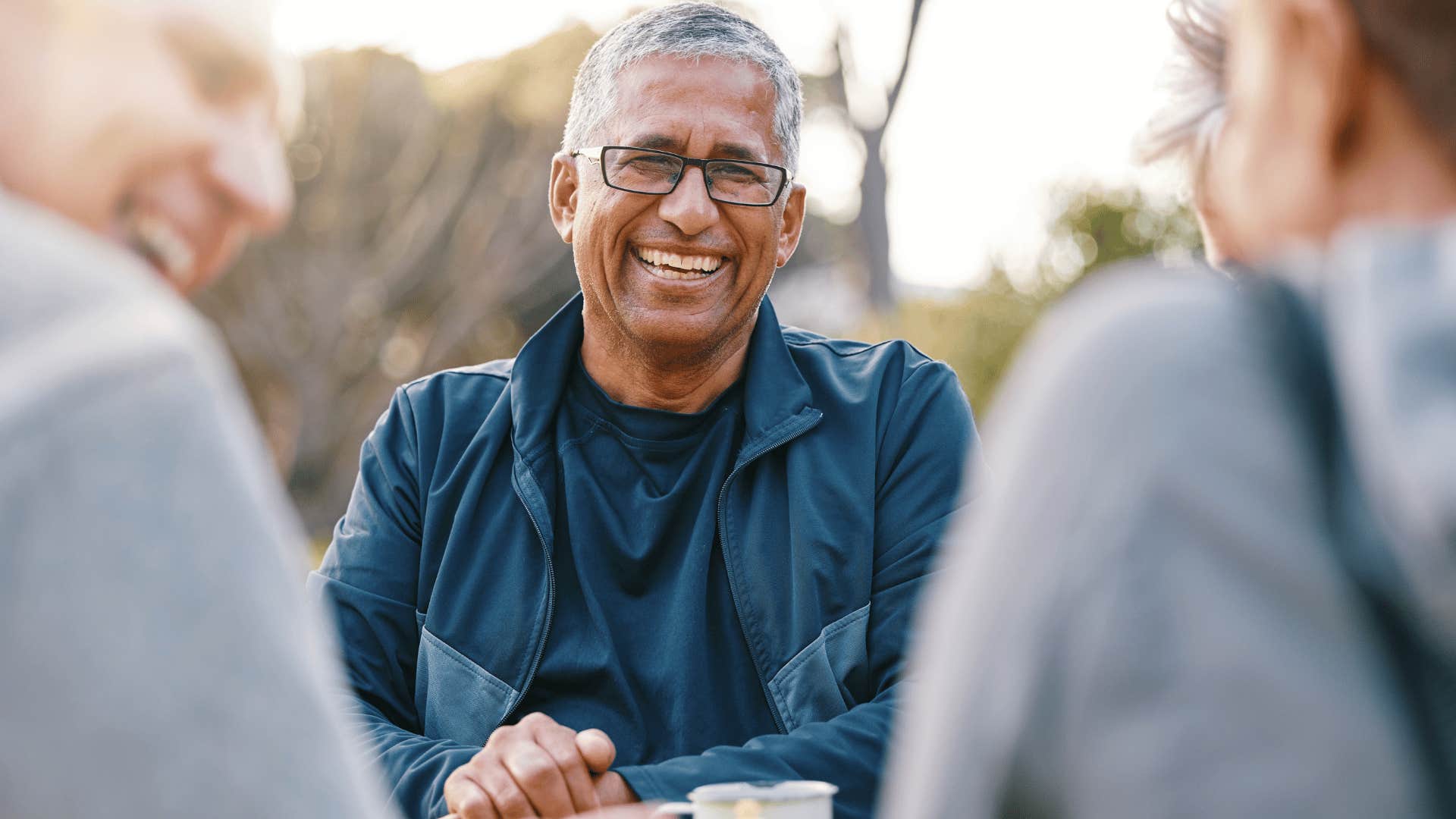 man looking at people talking