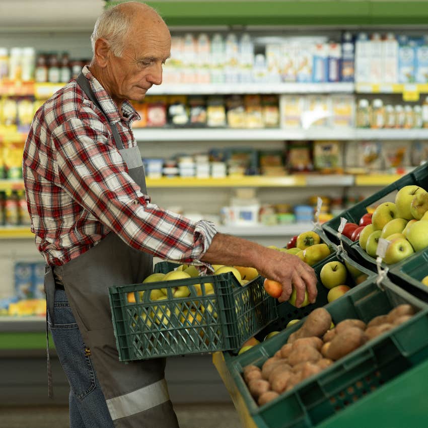 Elderly man working at a grocery store