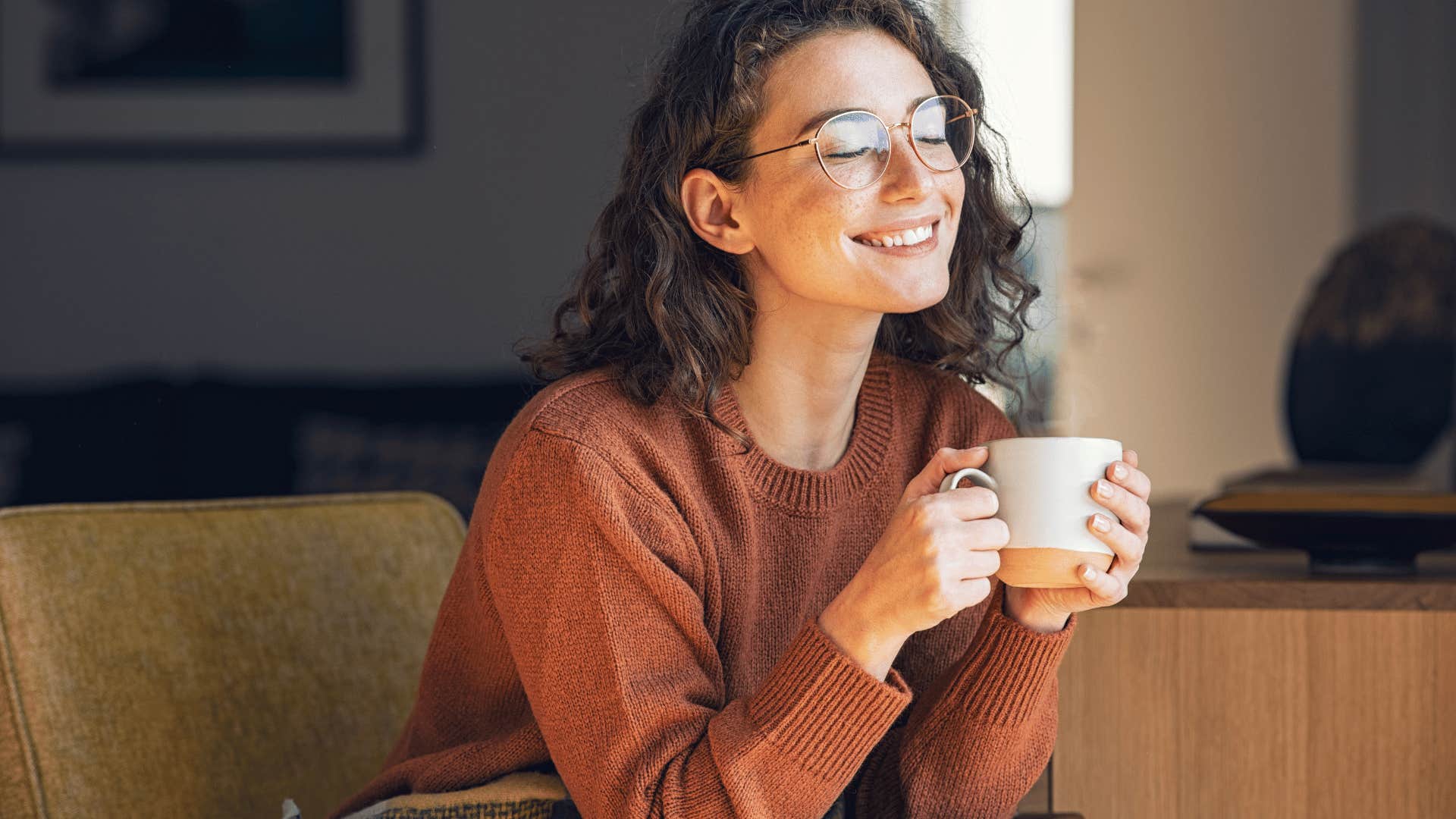 woman drinking coffee and smiling