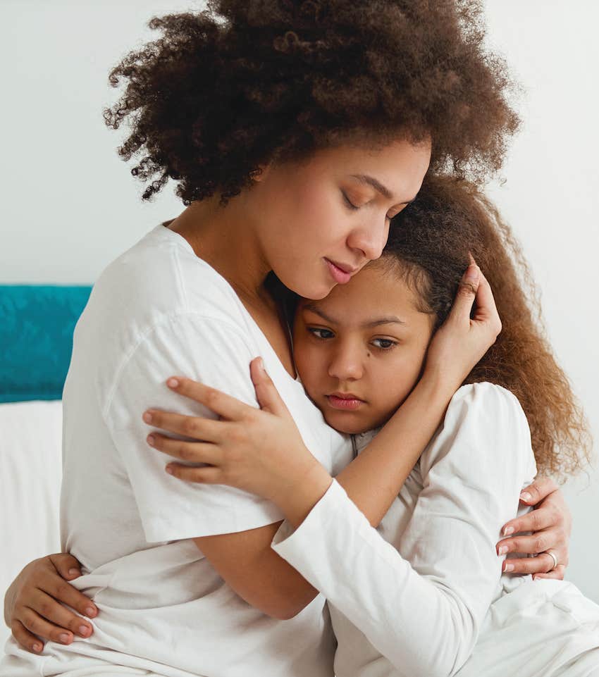 Calm mother hugs emotionally healthy child