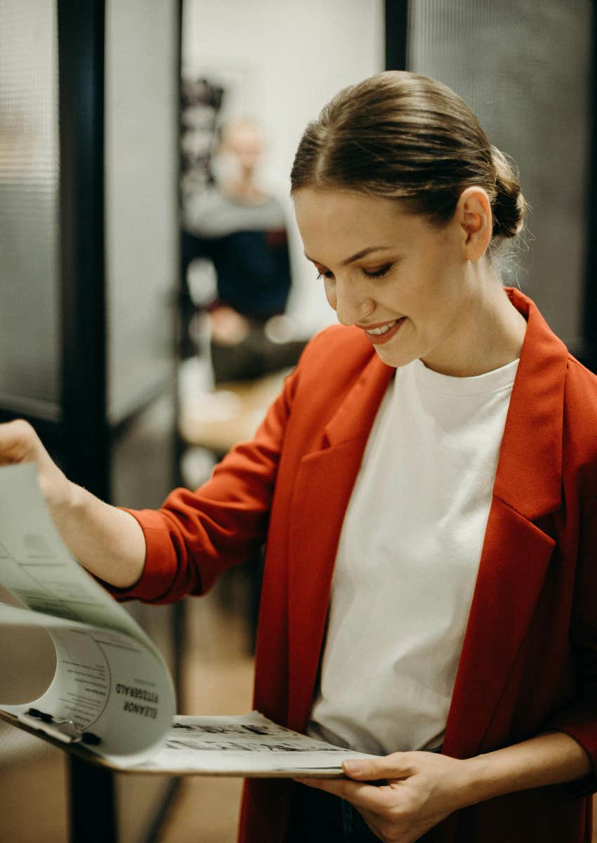 employee looking through paperwork on a clipboard