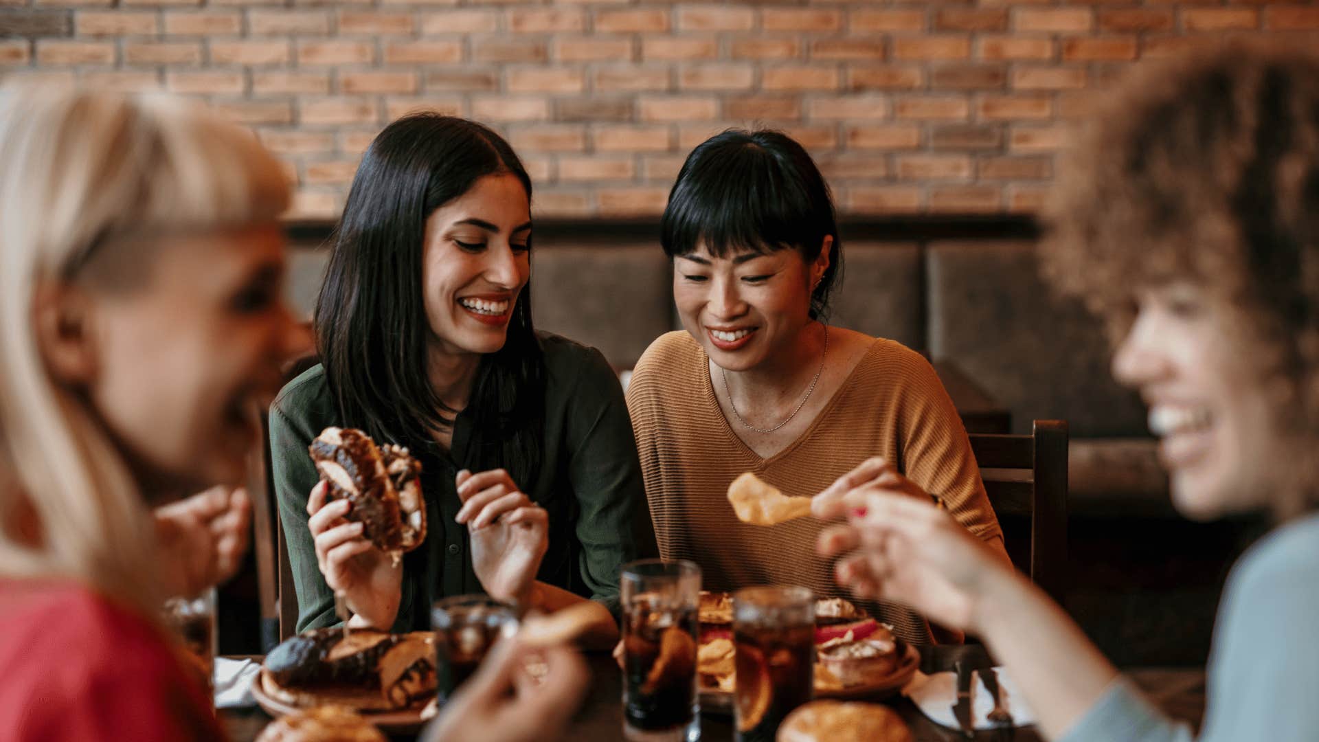 Two couples share a meal in a restaurant as a tradition