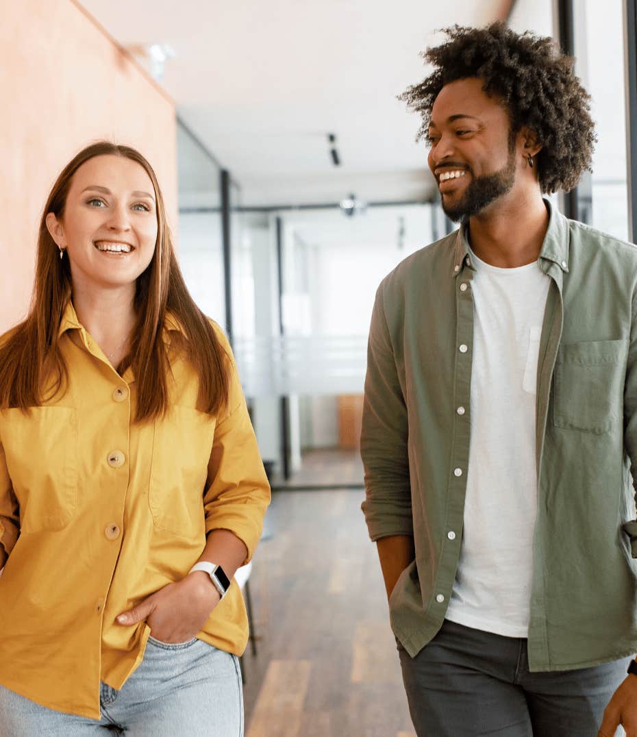 Woman and man meet while walking in hallway