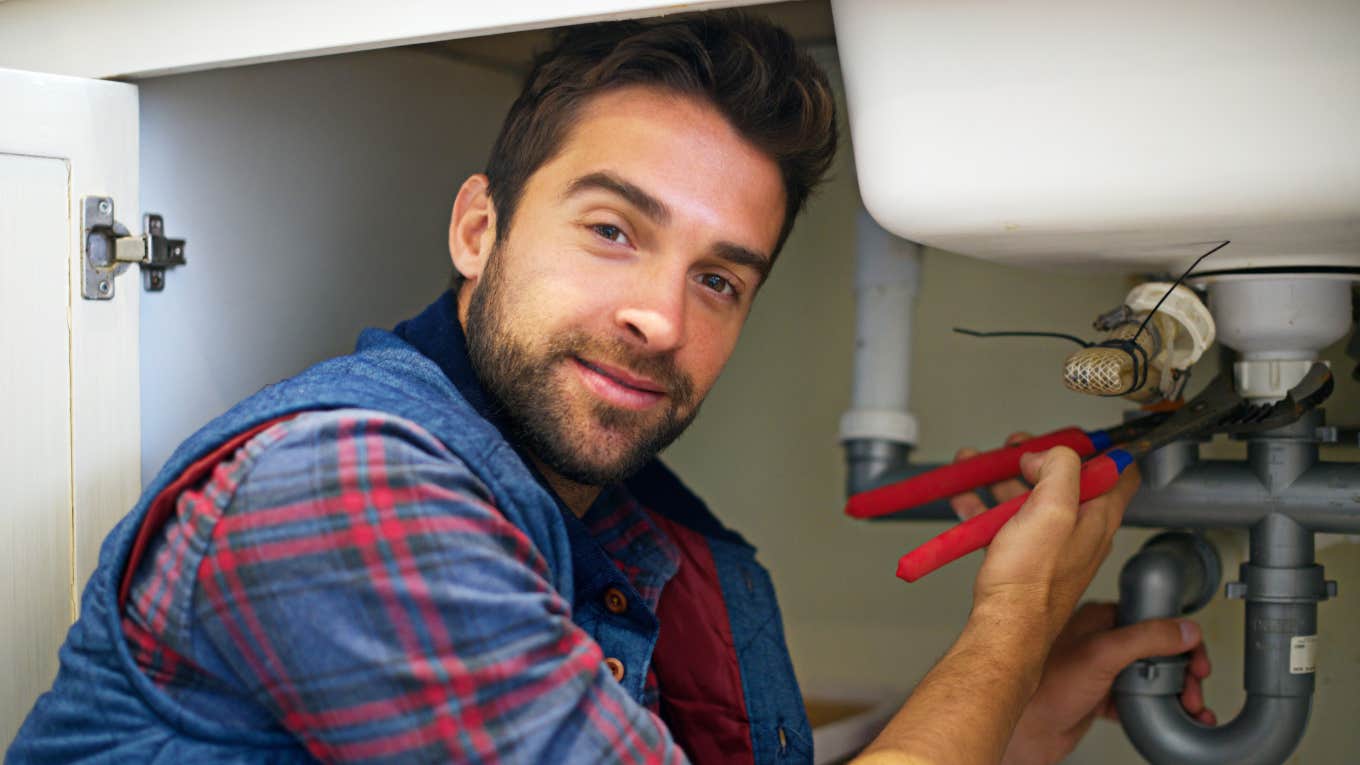 Plumber working on sink