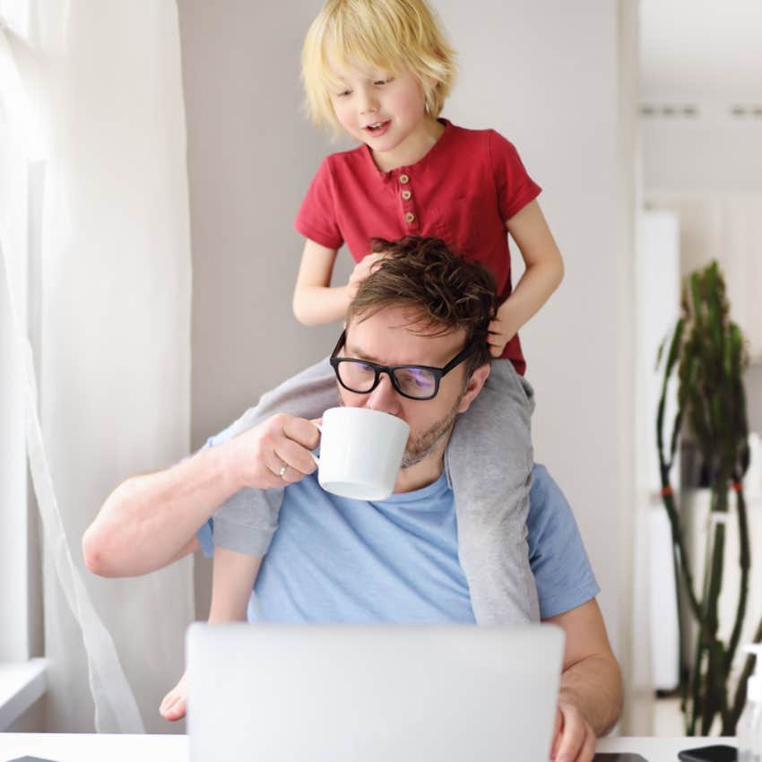 father working from home with son on shoulders 