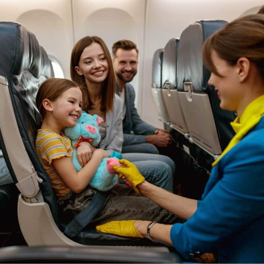 flight attendant talking to passengers 