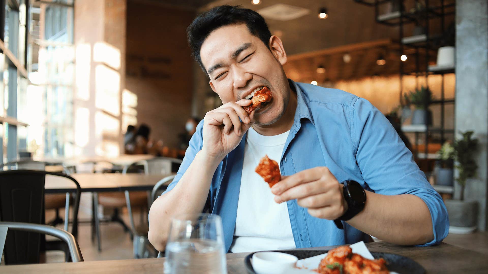 man eating chicken wings