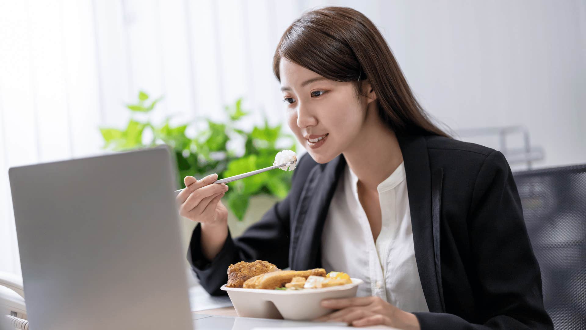 woman eating food while working