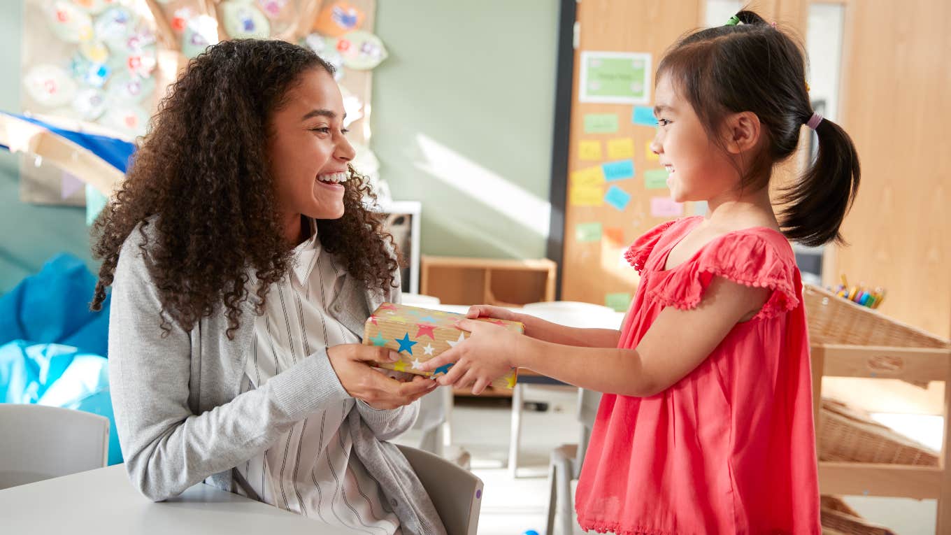 Student giving her teacher a gift