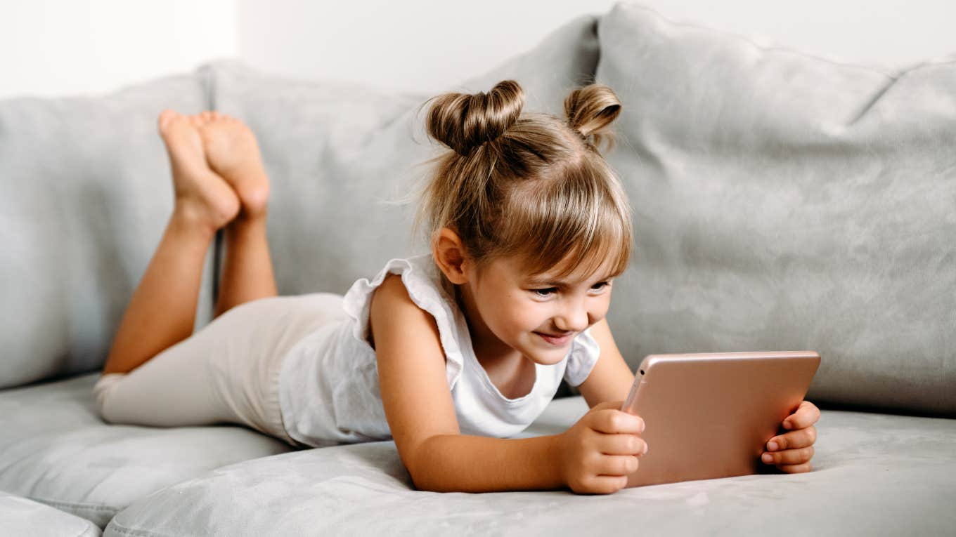 toddler girl playing with tablet