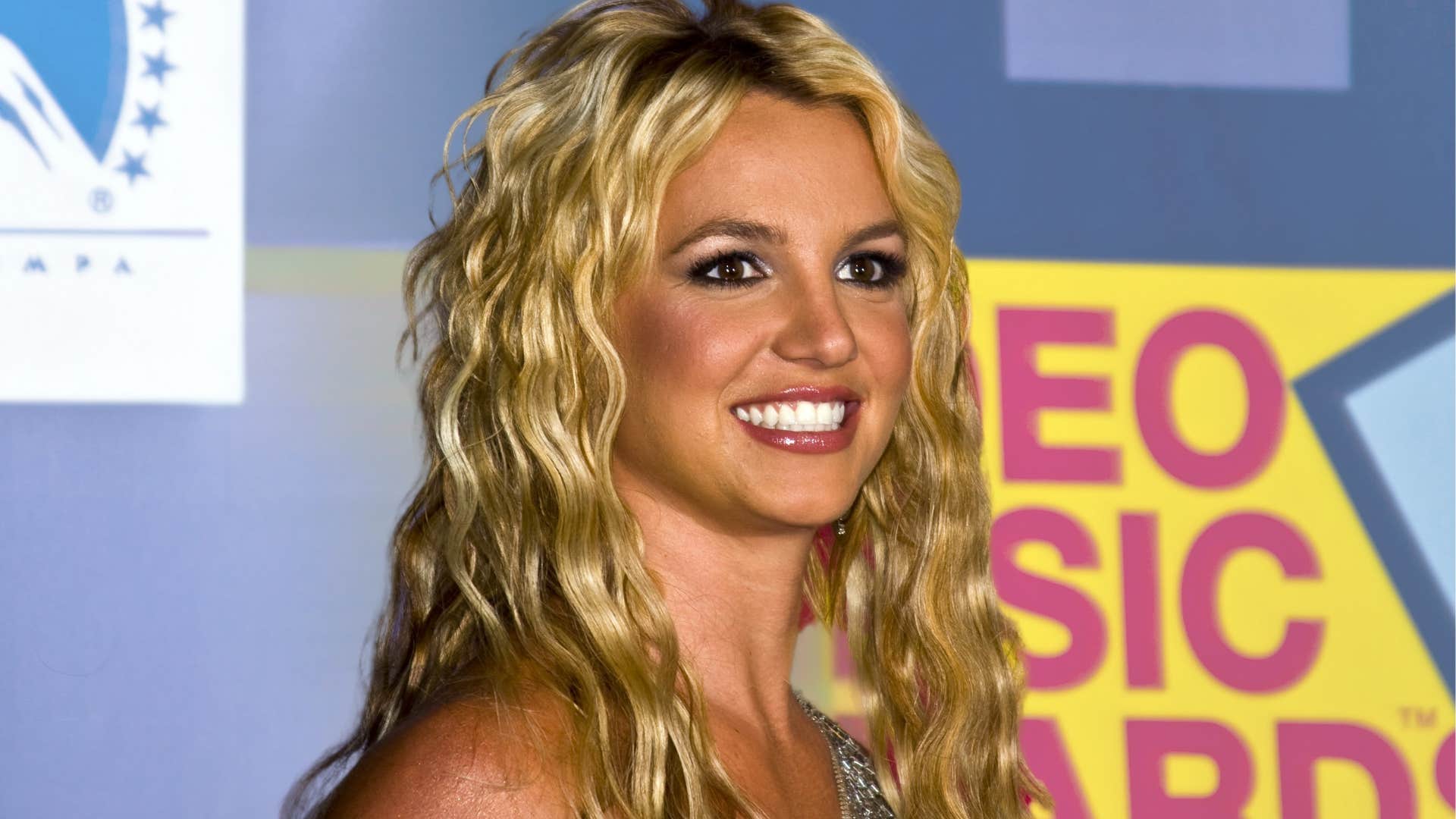 Young Britney Spears smiling on a red carpet