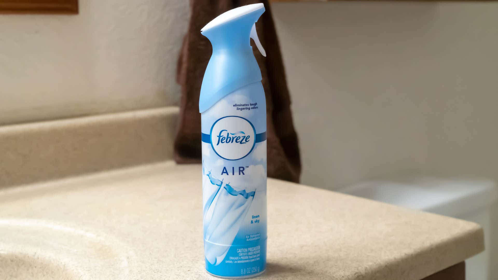 Bottle of Febreze spray sitting on a bathroom counter