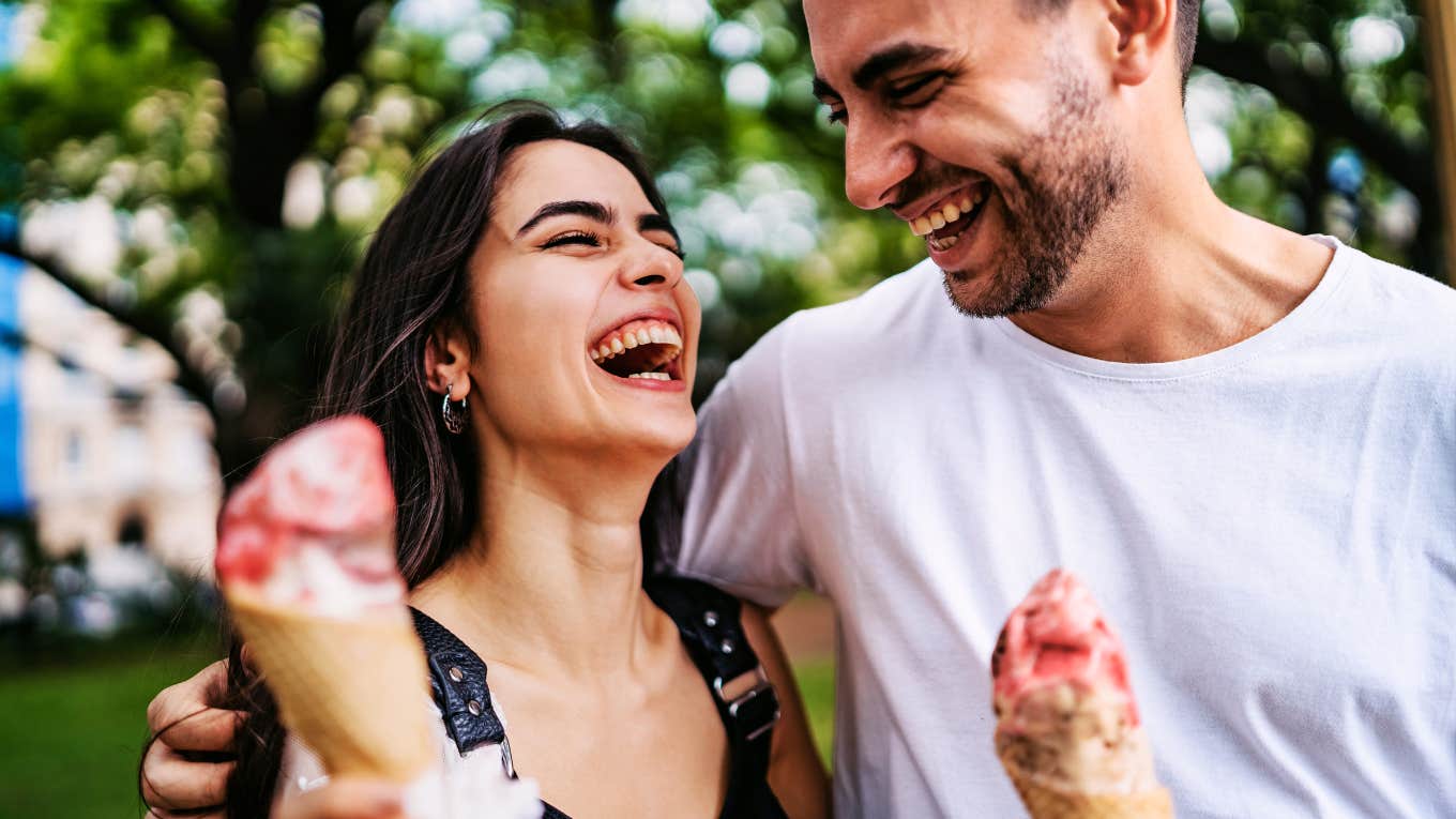 Truly happy and thriving couple, smiling while eating ice cream.