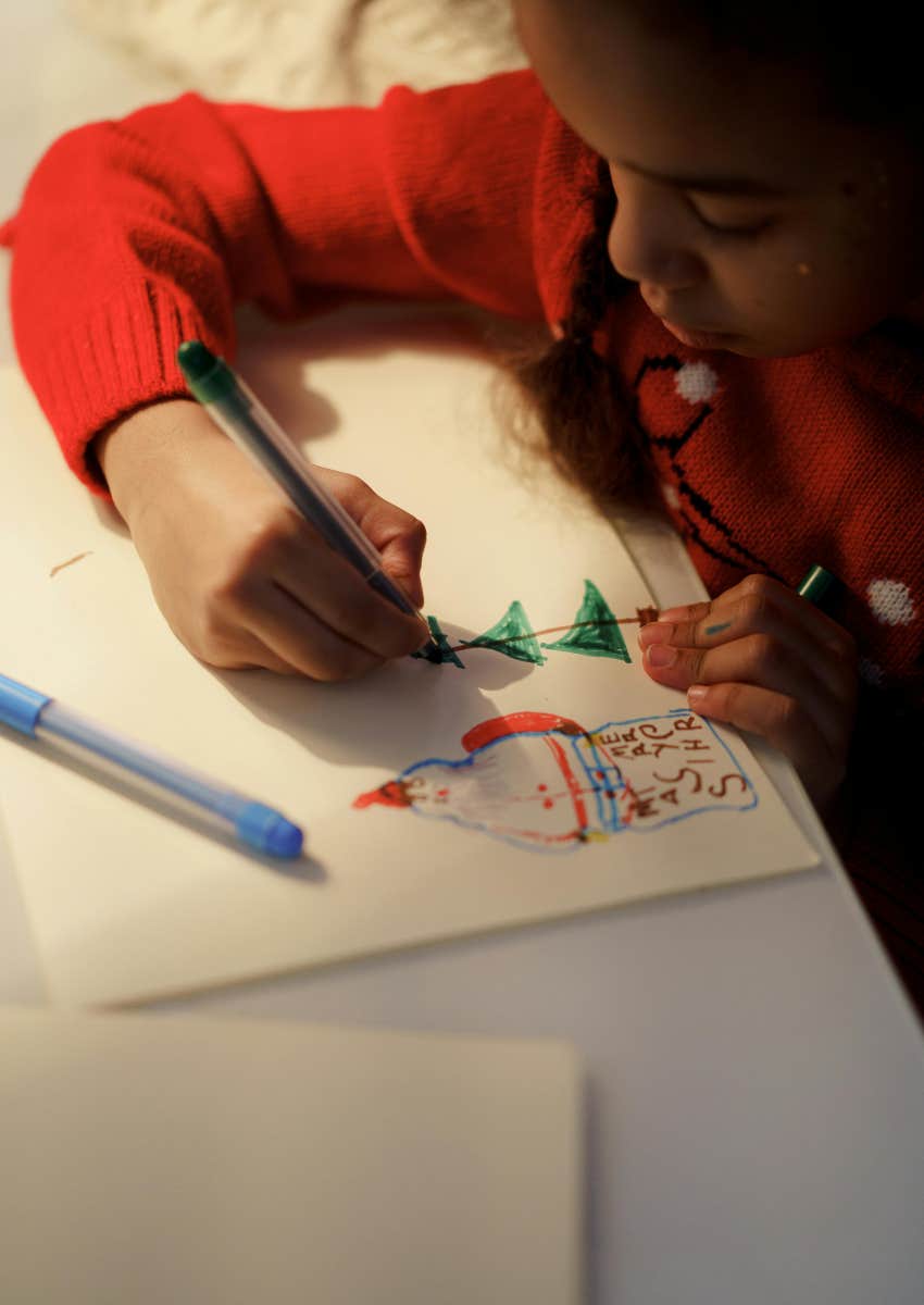 little girl drawing a picture of Santa