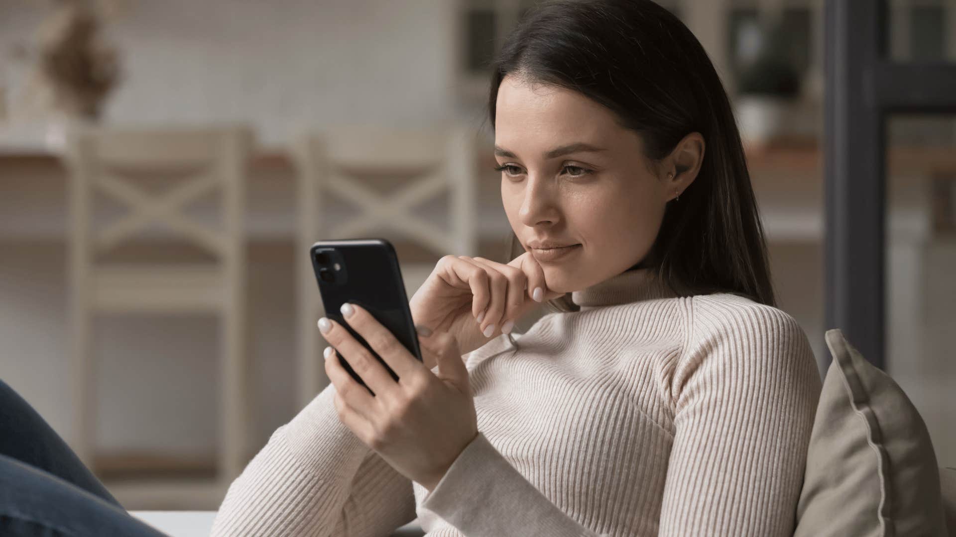 Woman sitting down looking at her phone