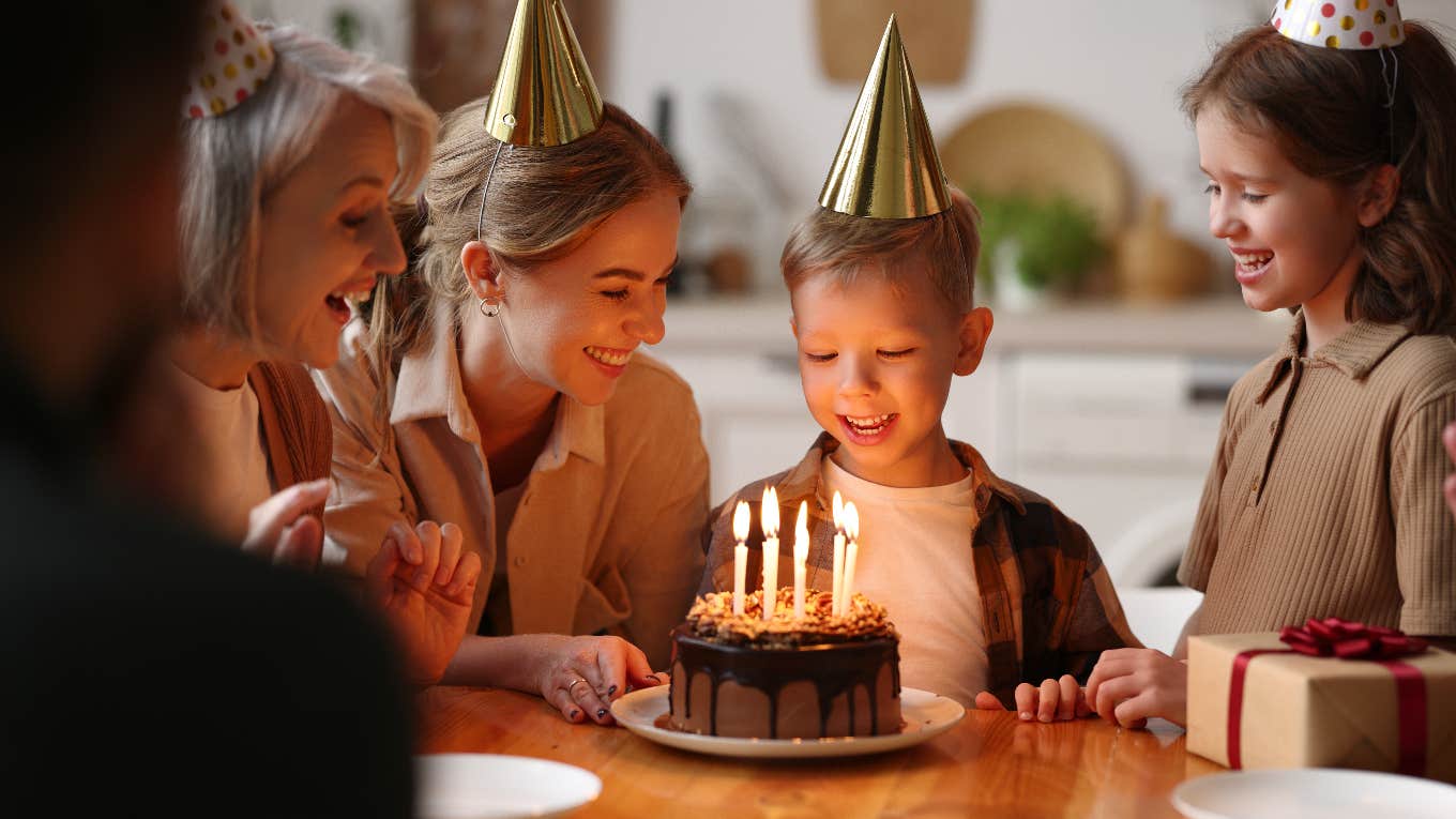 Grandson blowing out the candles on his birthday cake