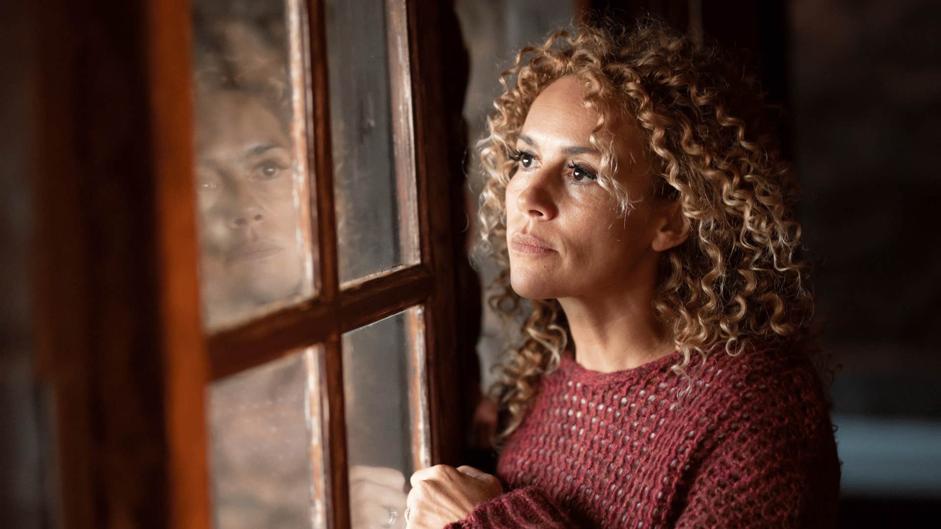 woman looking out the window