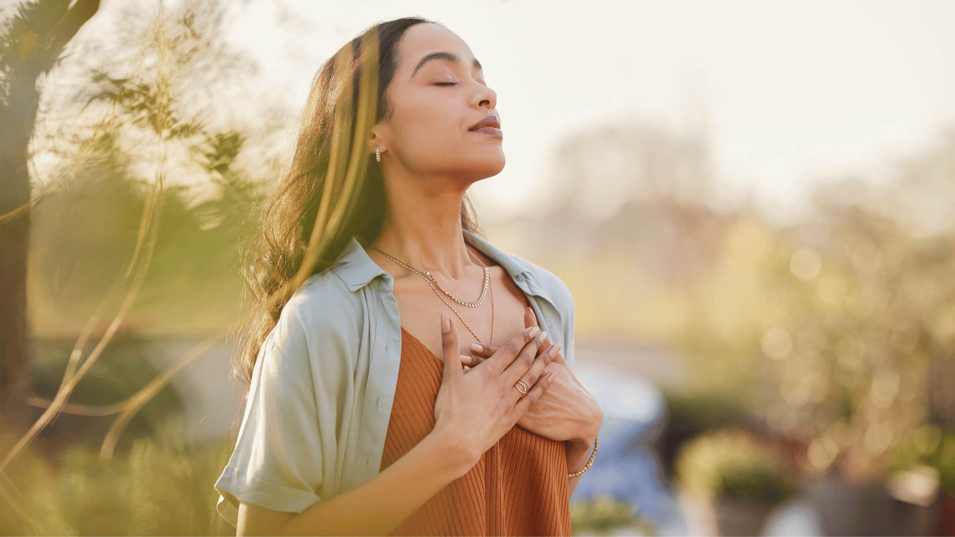 woman deep breathing outside 