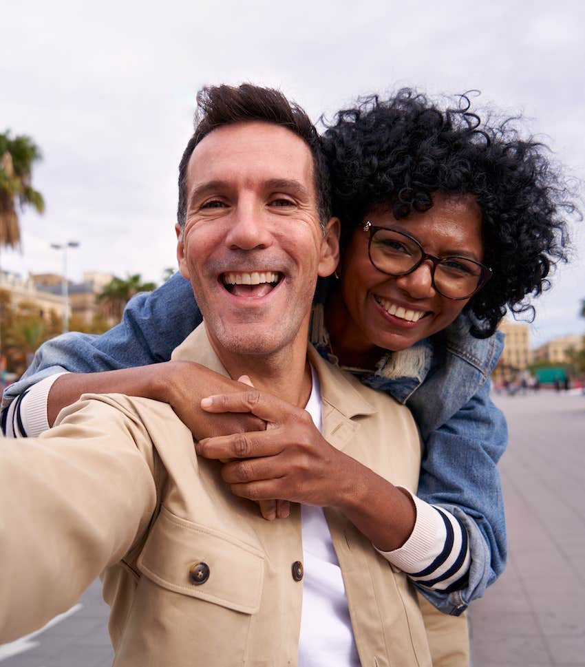 Man takes selfie with happy woman he is attracted to