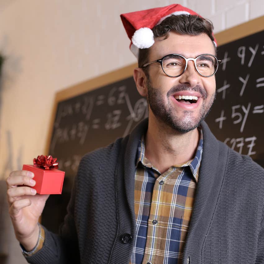 Happy teacher holding a holiday gift from a student