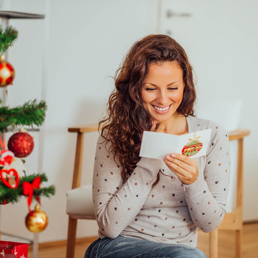 Happy woman reading a holiday card