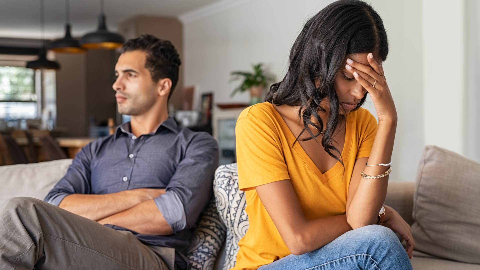 Woman looking upset next to her angry husband.