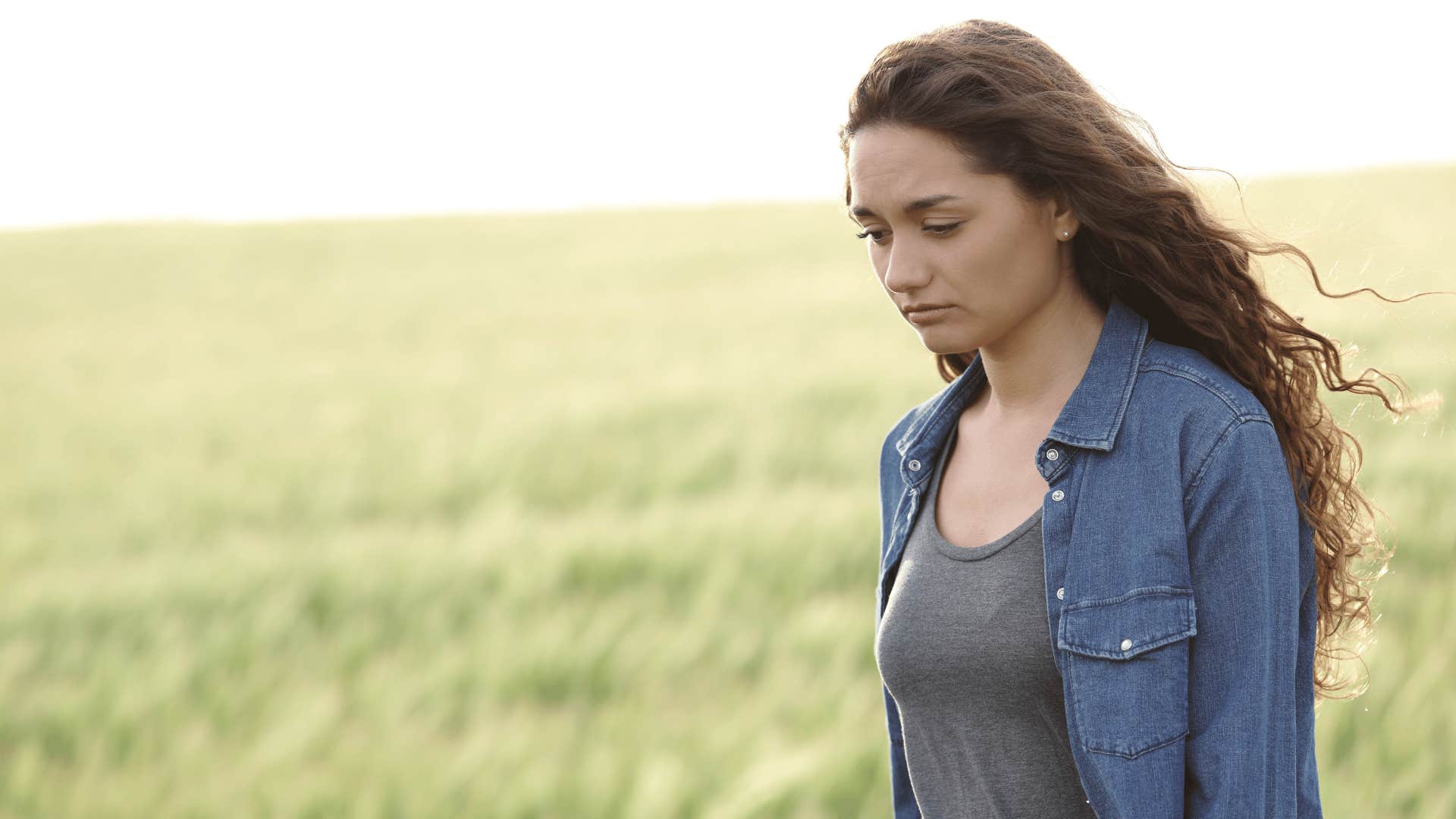 Woman in a field, afraid of being alone