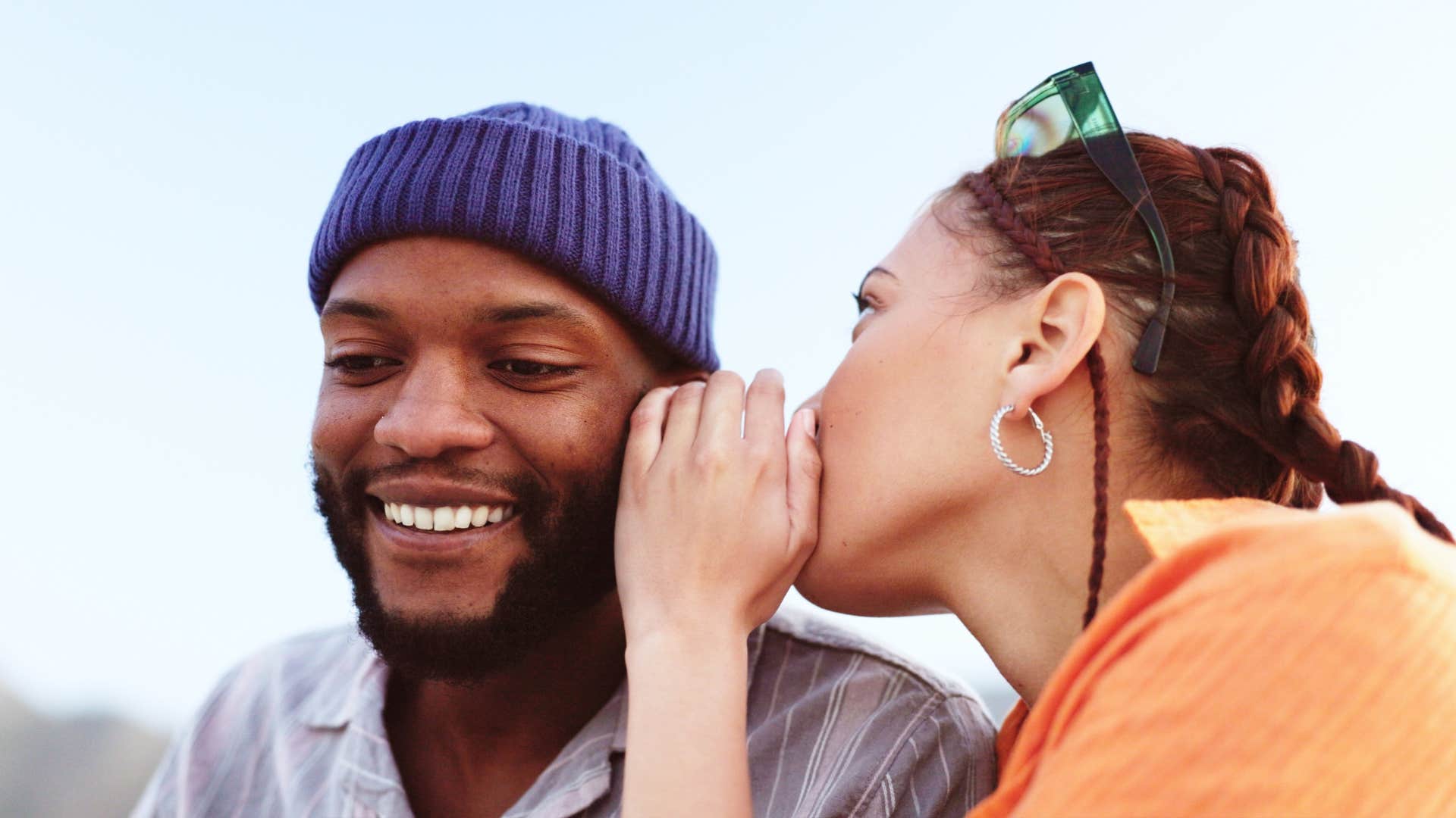 woman whispering to her guy friend