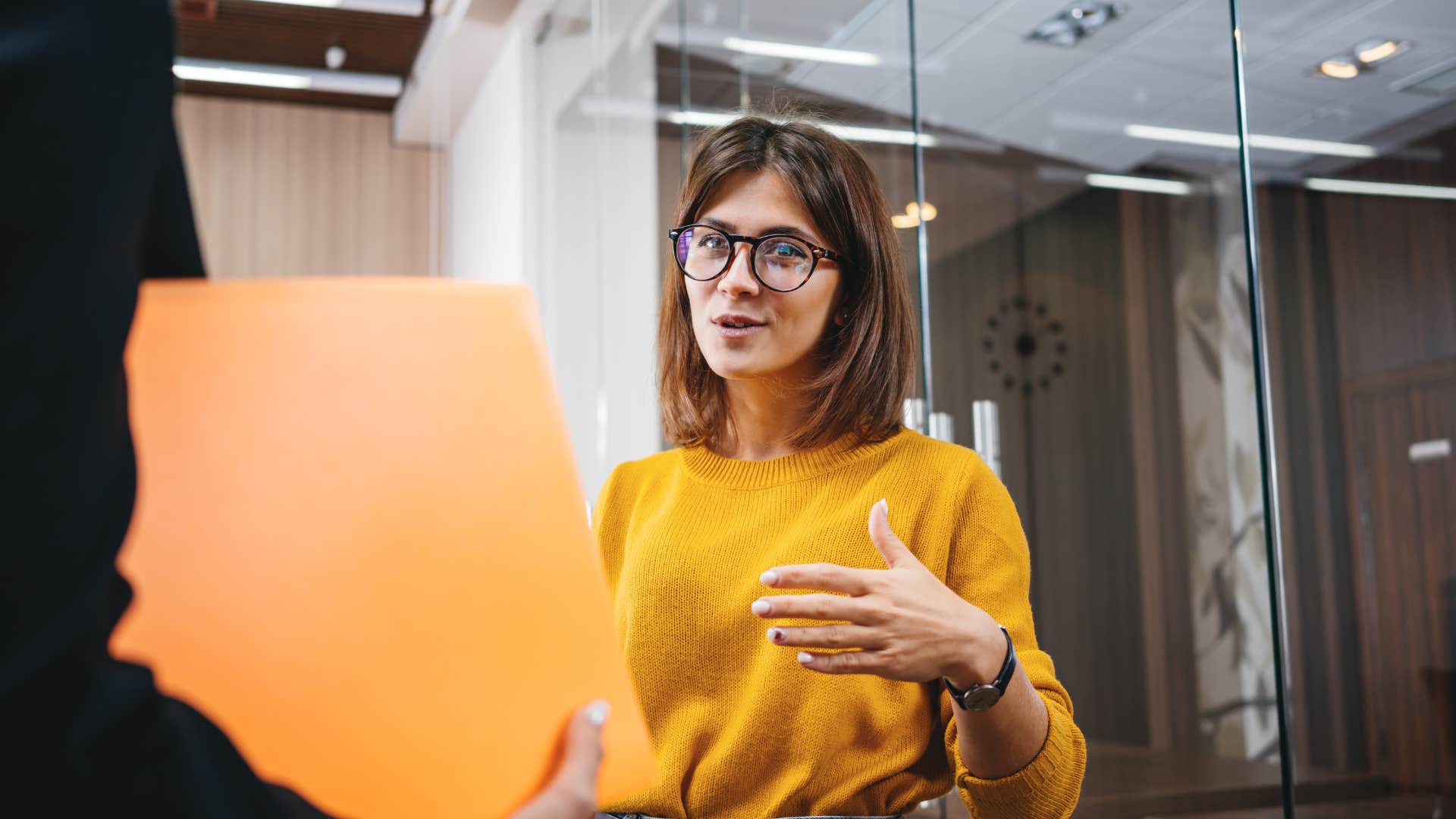 Group of positive female office employees have meeting at workplace at modern office