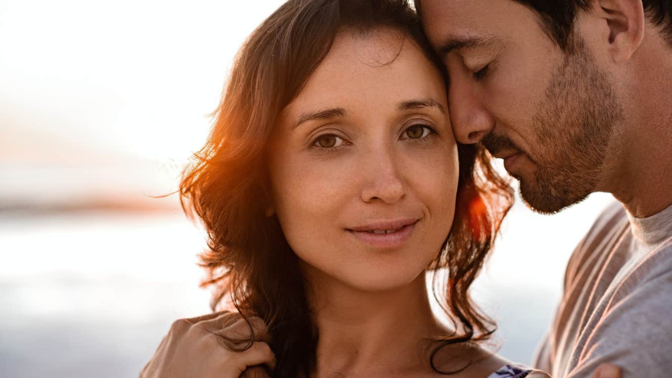 Husband nuzzling stressed out, burned out wife 