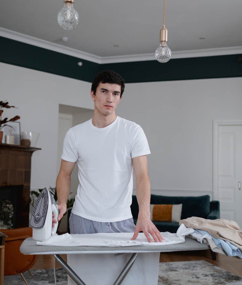 Man ironing clothes