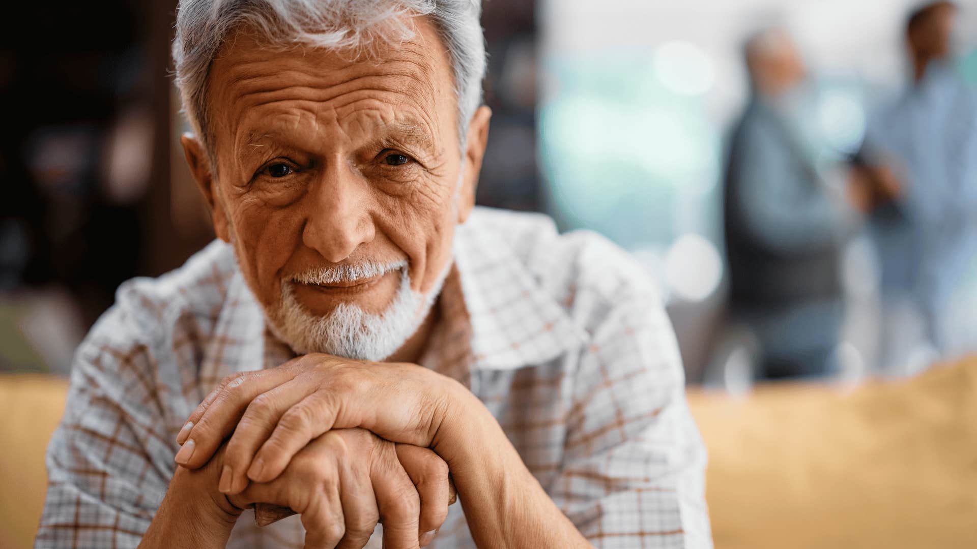 Elder man smiles and feels cool