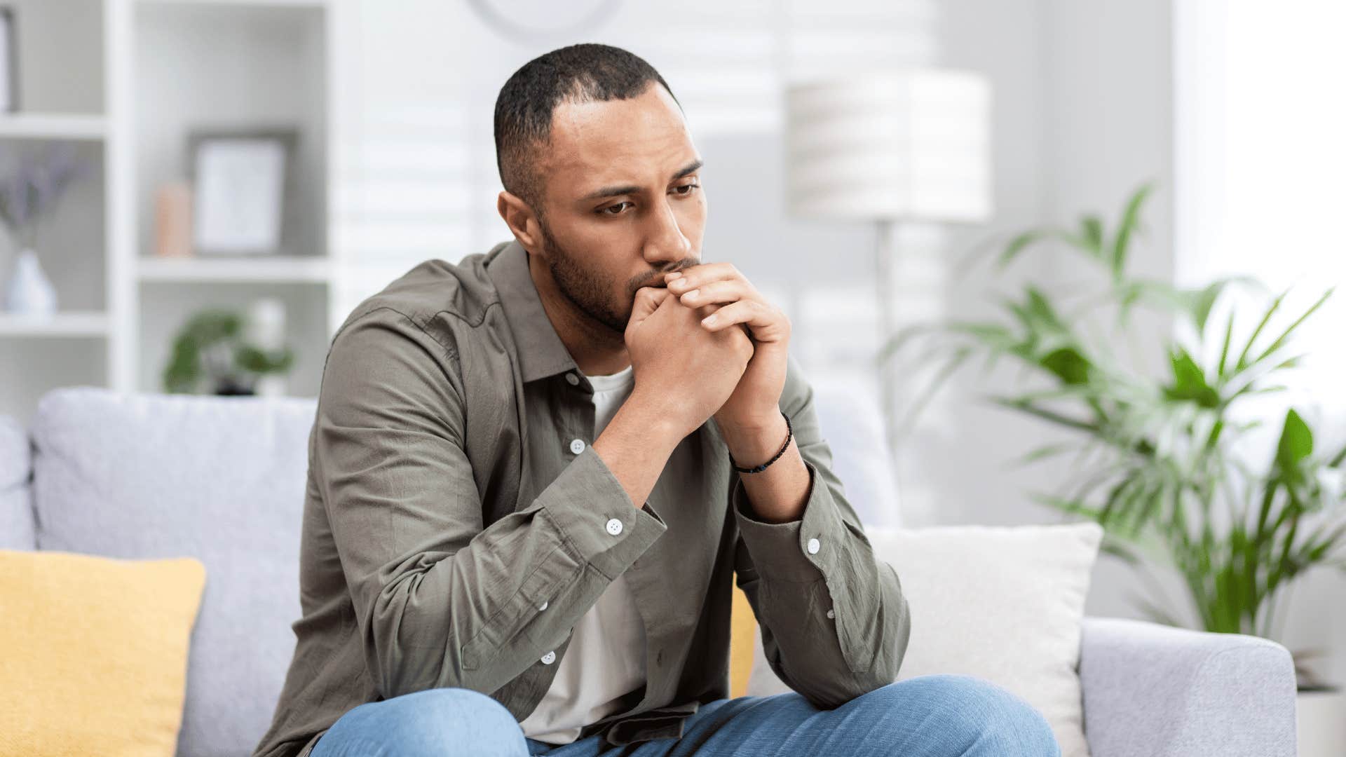 man thinking on couch